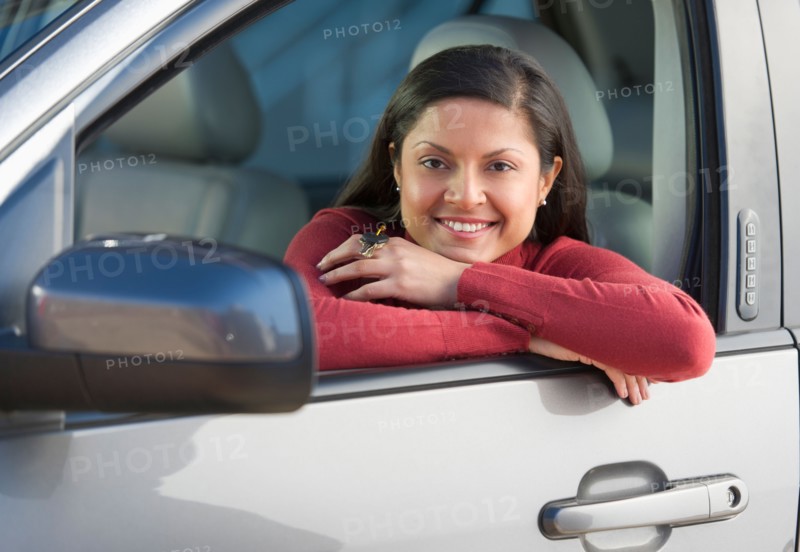 Woman sitting in her new car.