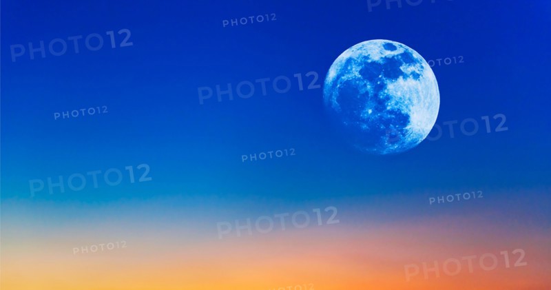 Full moon on evening sky.