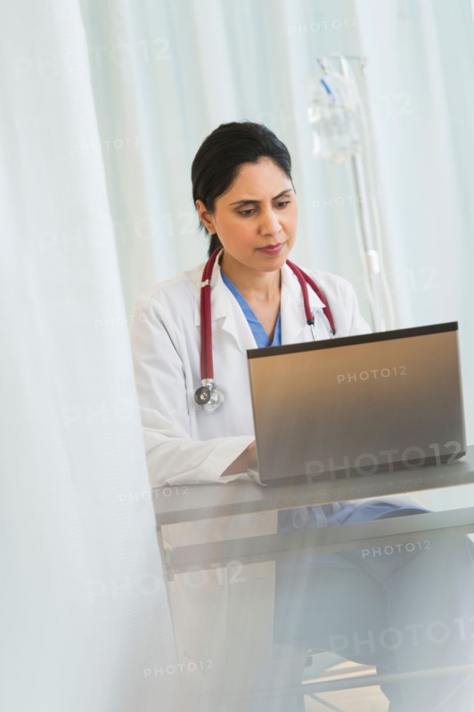 Doctor working on laptop.