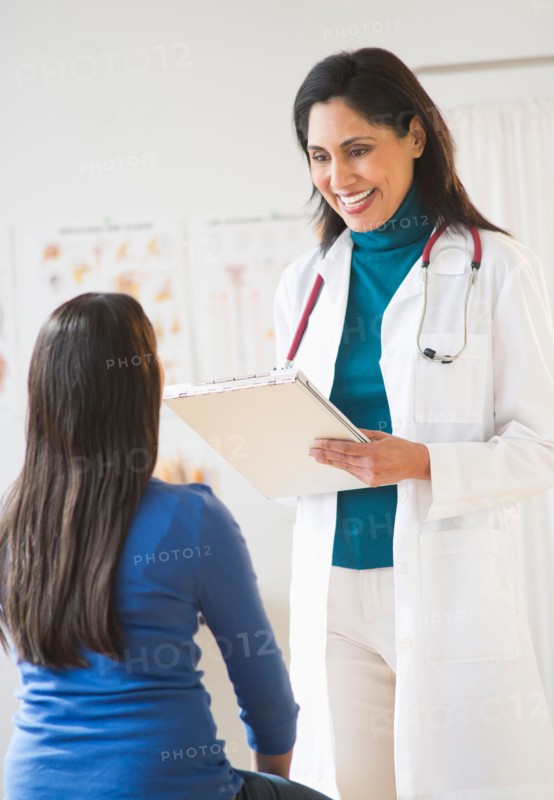 Doctor and patient (12-13) in doctor's office.