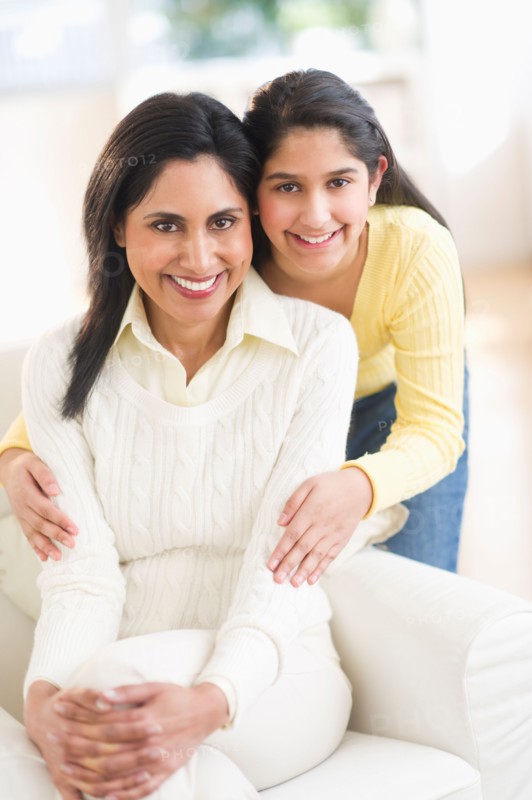 Portrait of mother and daughter (12-13) at home.