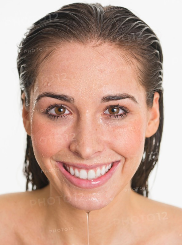 Studio portrait of woman with wet face.