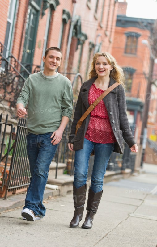 Couple walking on street.