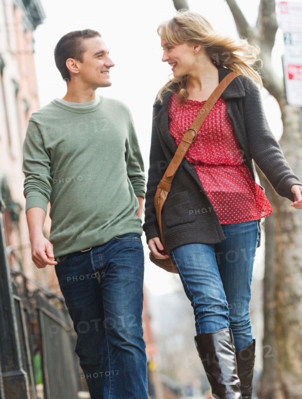 Couple walking on street.