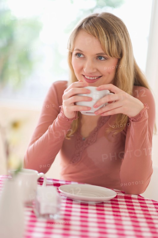 Portrait of woman sitting at table.