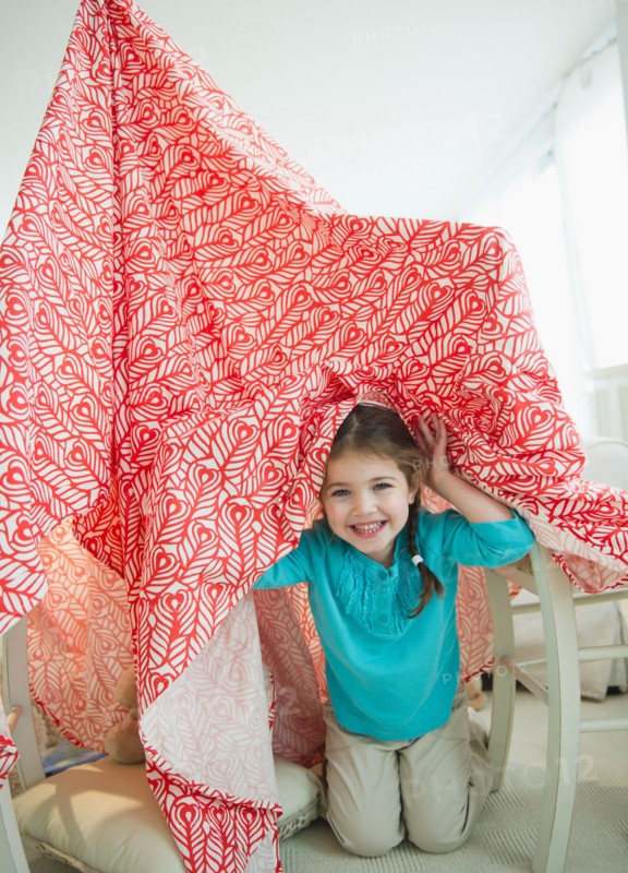 Small girl  (4-5 years) playing with curtain. Photo : Jamie Grill