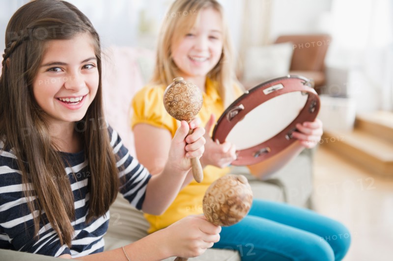 Two girls playing music on instruments. Photo : Jamie Grill