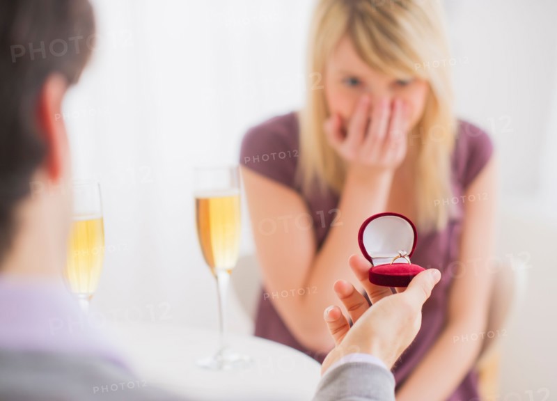 Couple celebrating engagement in restaurant. Photo : Daniel Grill