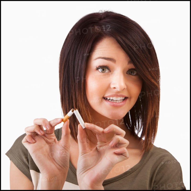 Young woman breaking cigarette. Photo : Mike Kemp