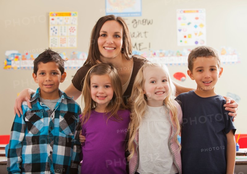 Teacher with children (2-3, 4-5, 6-7) at school. Photo : Mike Kemp