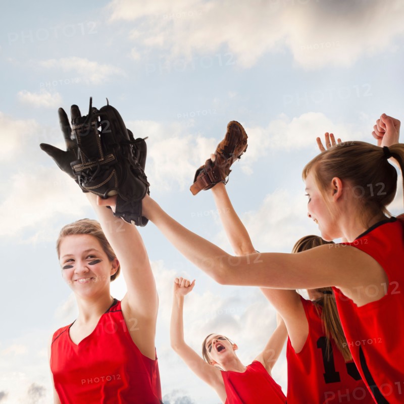Girls (12-13) celebrating during playing softball. Photo : Mike Kemp