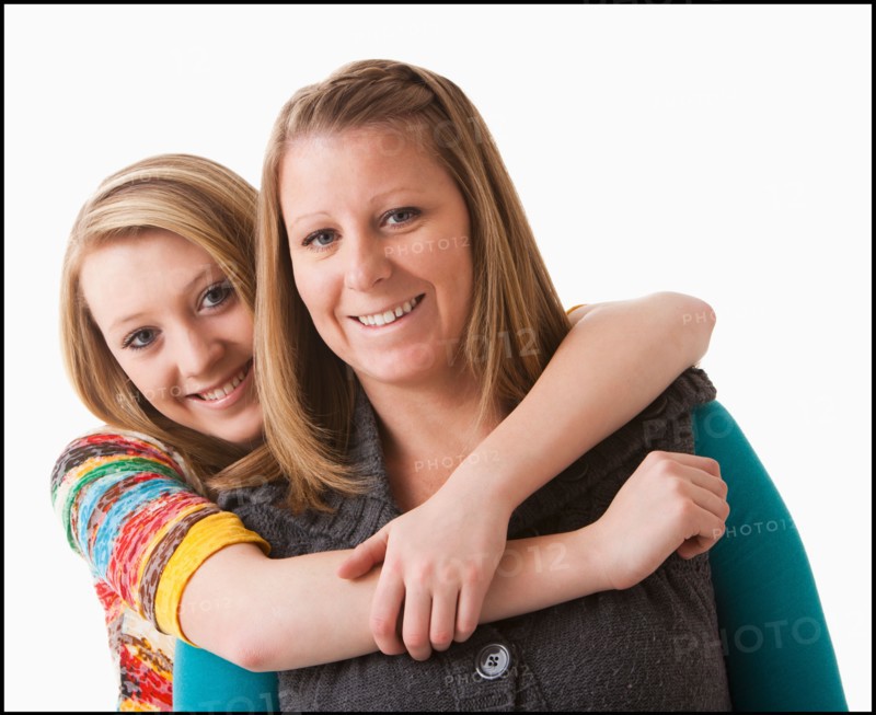 Studio shot of girl (12-13) with mother. Photo : Mike Kemp