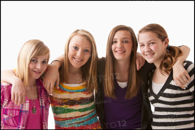 Studio shot of four happy girls (12-13). Photo : Mike Kemp