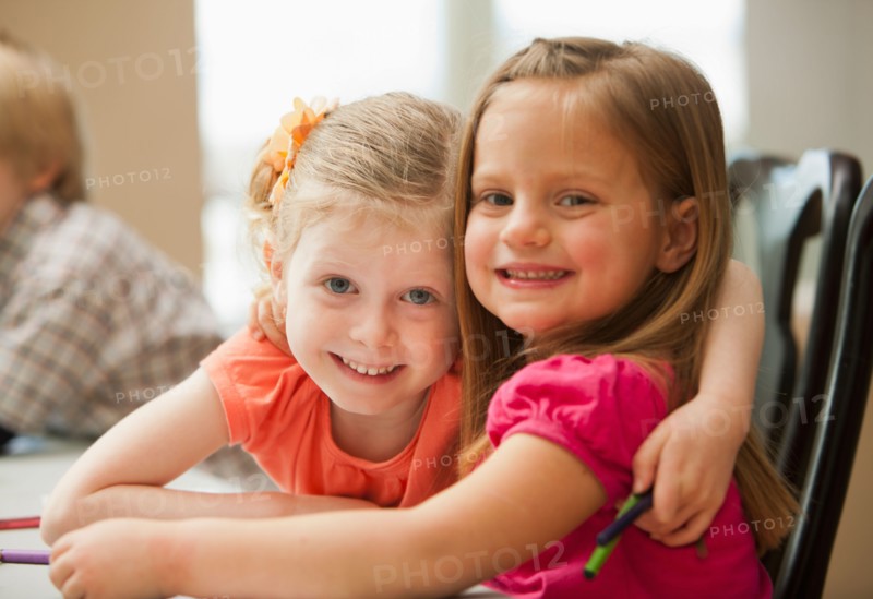 Portrait of girls (4-5)  looking at camera in kindergarten. Photo : Mike Kemp