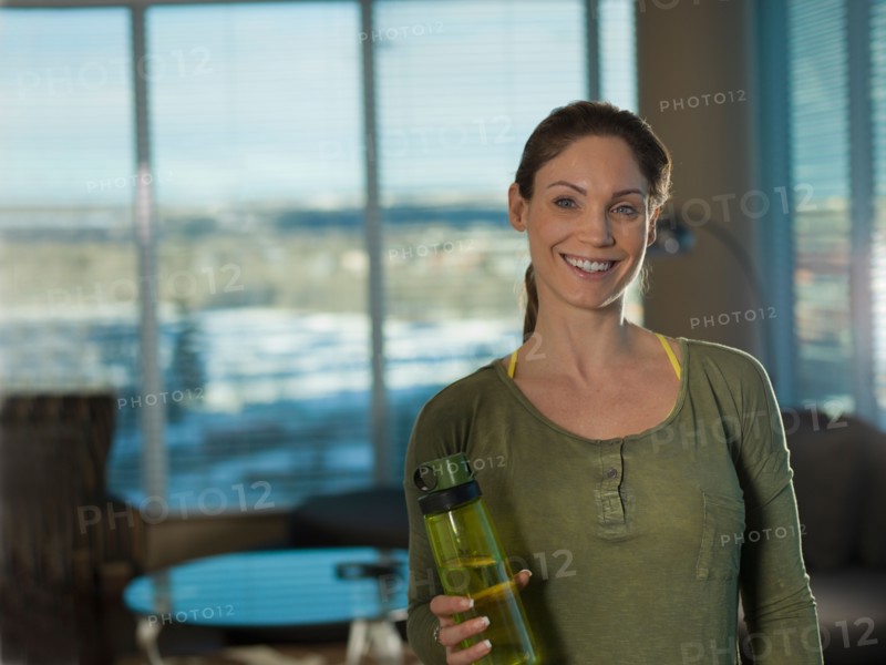 Portrait of mid adult woman exercising at home. Photo : Dan Bannister