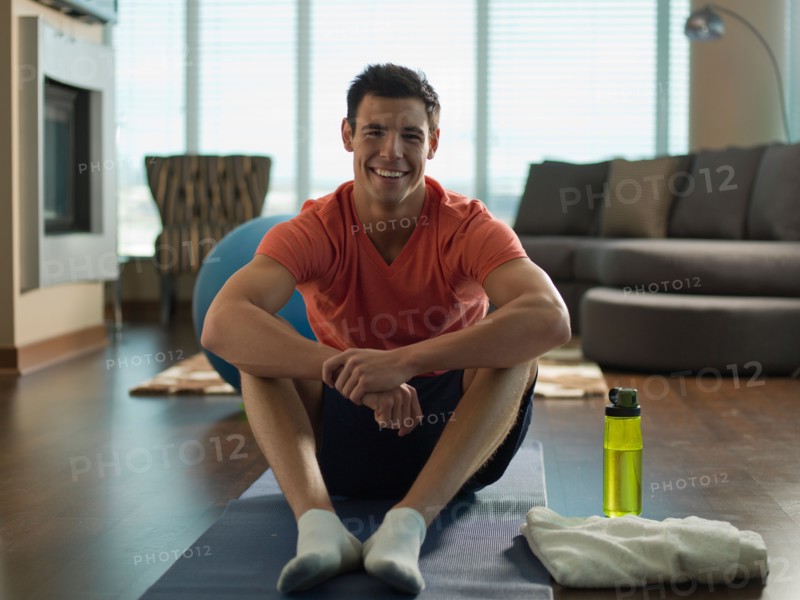Portrait of Young man exercising at home. Photo : Dan Bannister