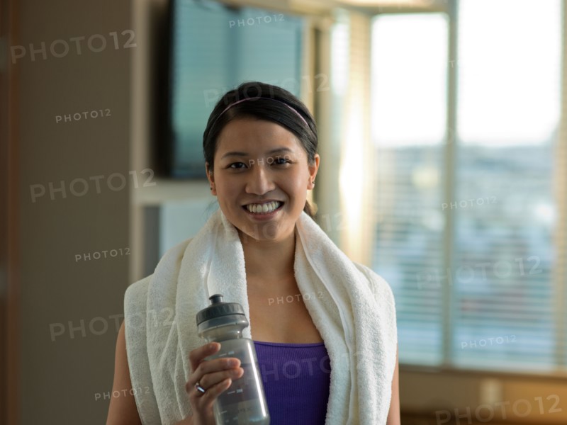 Portrait of Young woman exercising at home. Photo : Dan Bannister