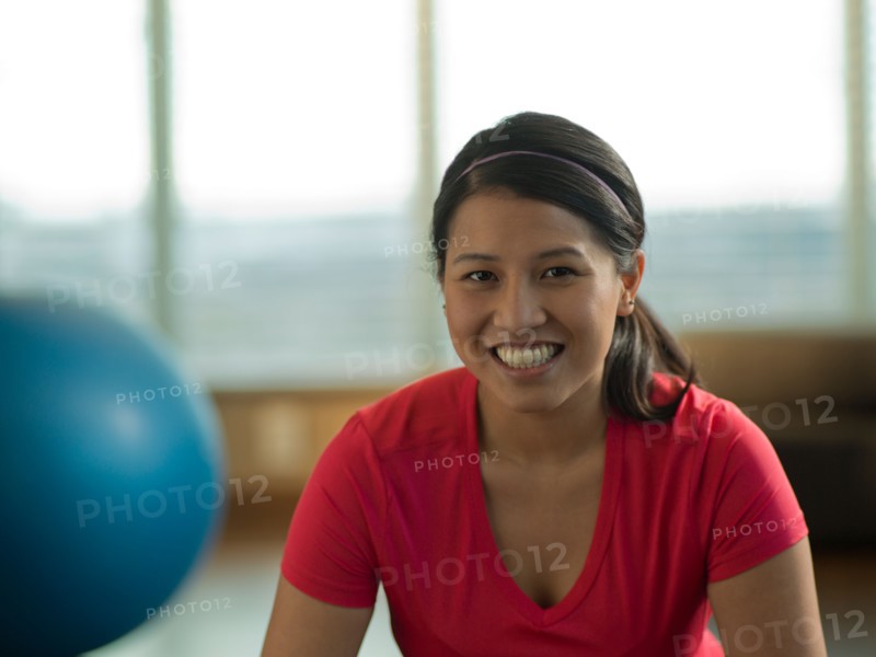 Portrait of Young woman exercising at home. Photo : Dan Bannister