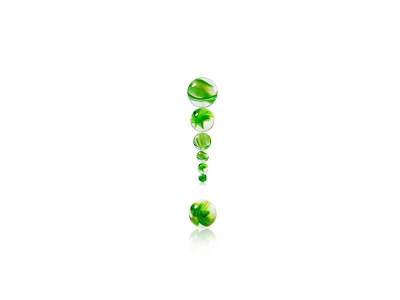 Studio shot of green marbles arranged in Exclamation Point. Photo : David Arky