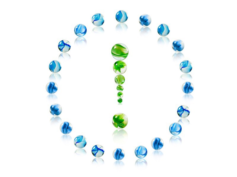 Studio shot of green marbles arranged in Exclamation Point. Photo : David Arky