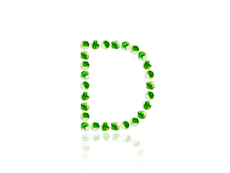 Studio shot of green marbles arranged in Exclamation Point. Photo : David Arky