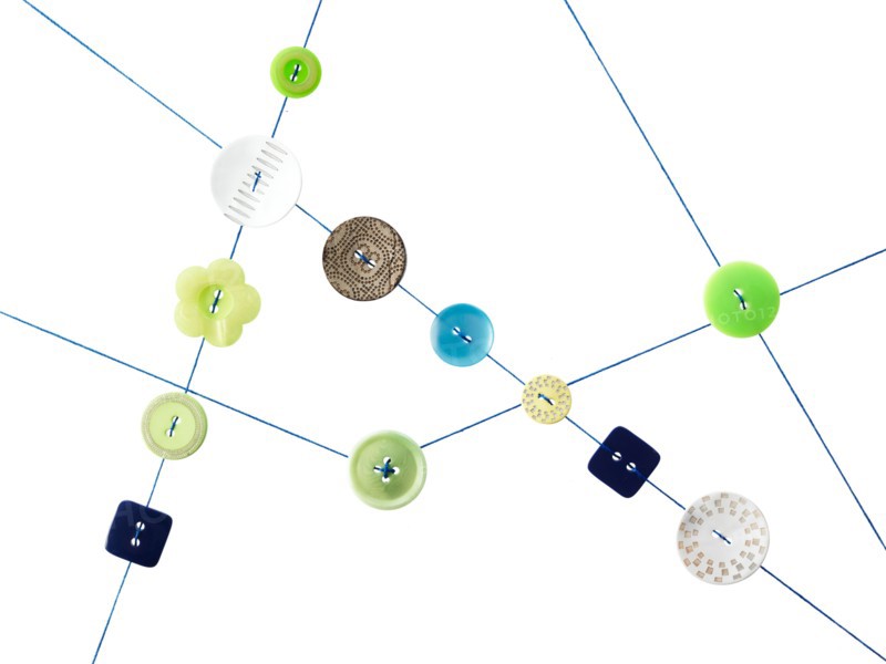Studio shot of diagram made of thread and buttons. Photo : David Arky