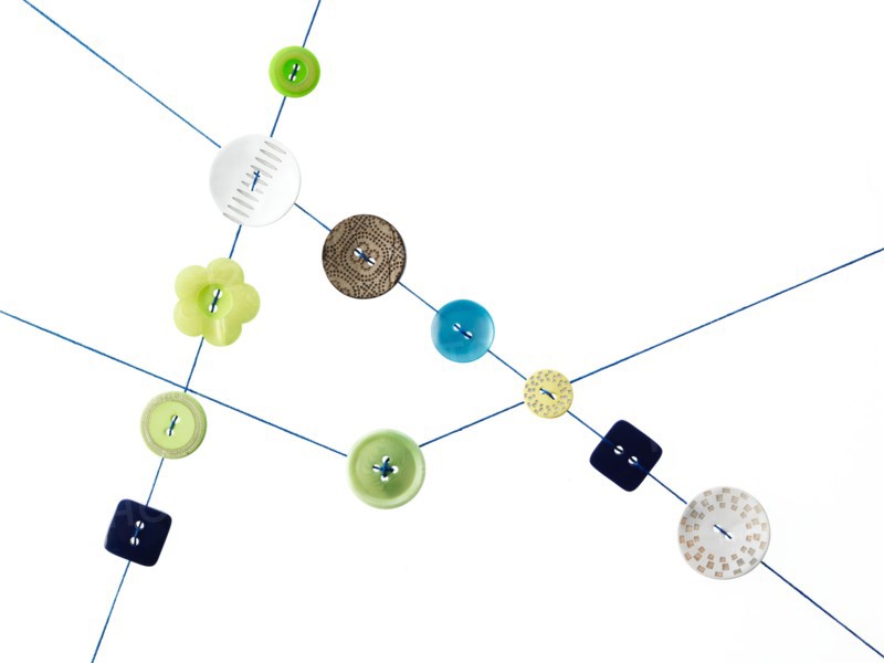 Studio shot of diagram made of thread and buttons. Photo : David Arky