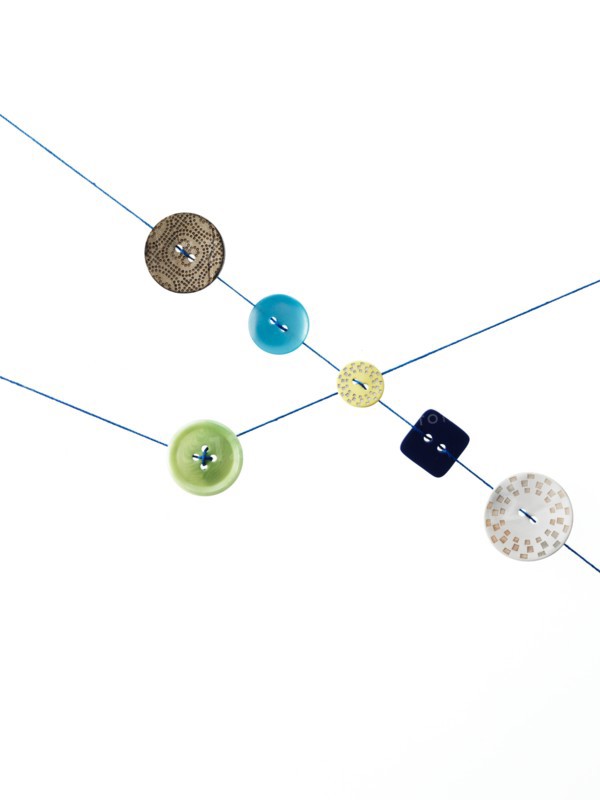 Studio shot of diagram made of thread and buttons. Photo : David Arky