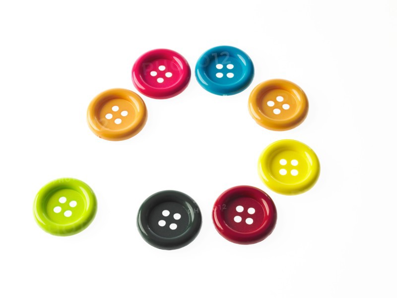 Studio shot of multi colored buttons arranged in circle. Photo : David Arky
