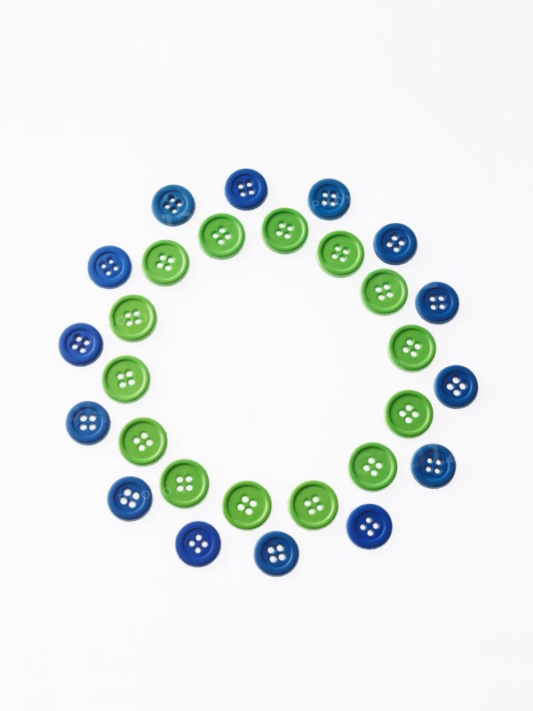 Studio shot of green and blue buttons arranged in circle. Photo : David Arky