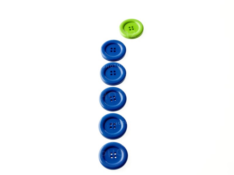Studio shot of blue and green buttons in a row. Photo : David Arky