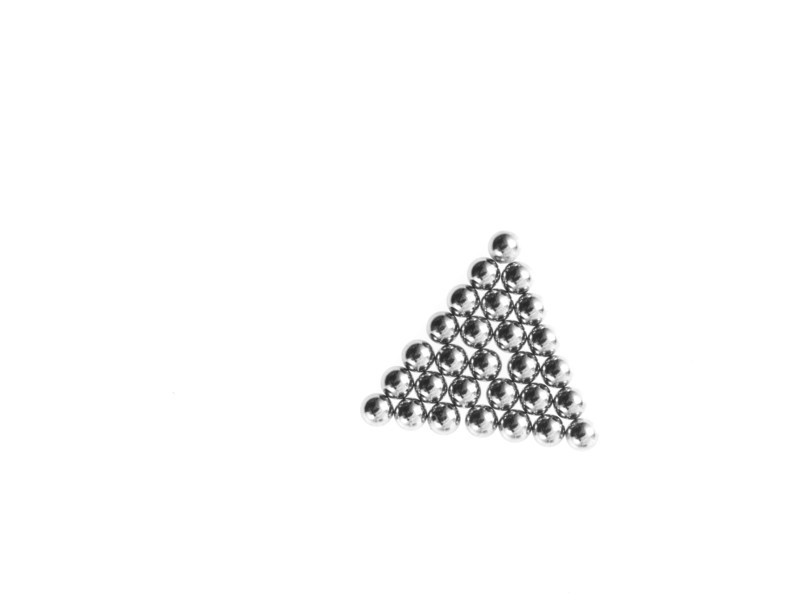 Studio shot of Pachinko balls arranged in triangle. Photo : David Arky