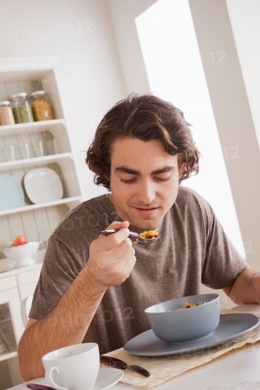 Young man eating. Photo : Rob Lewine