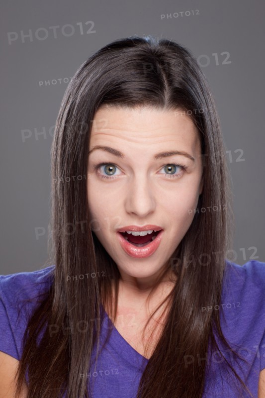 Studio shot of surprised young woman. Photo : Rob Lewine