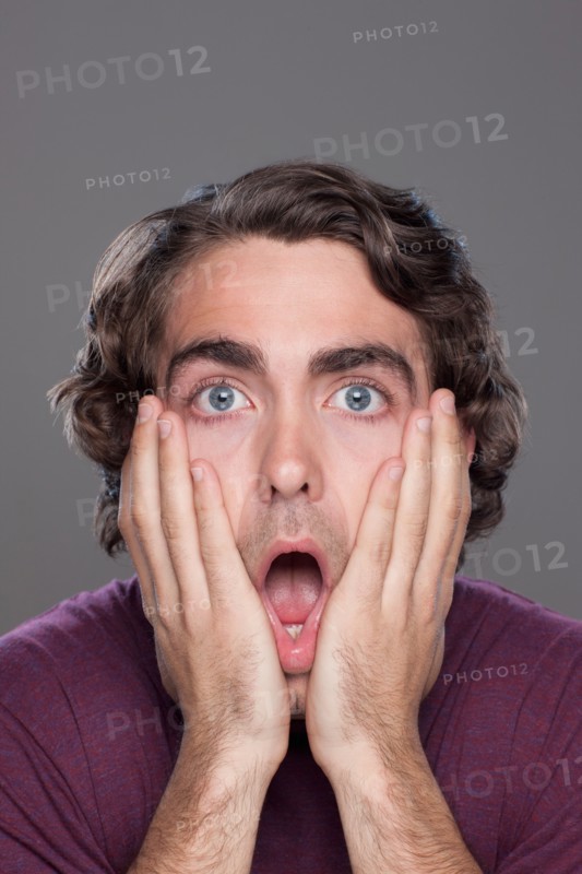 Studio shot of shocked young man. Photo : Rob Lewine