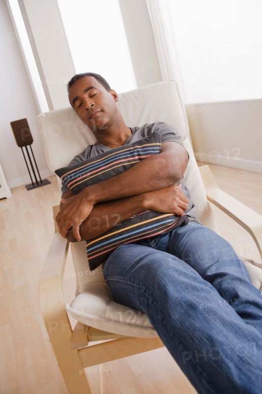 Mature man sleeping on armchair. Photo : Rob Lewine