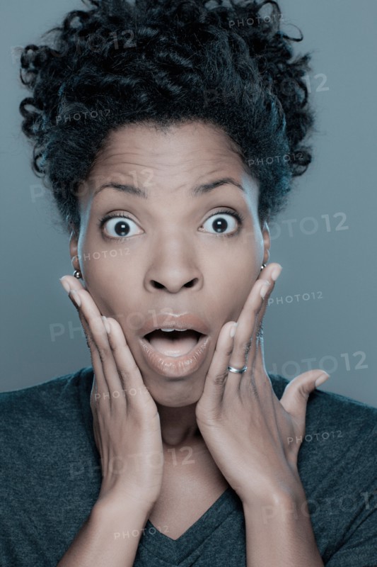 Studio shot of shocked young woman. Photo : Rob Lewine