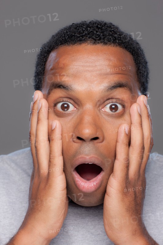 Studio shot of shocked mid adult man. Photo : Rob Lewine