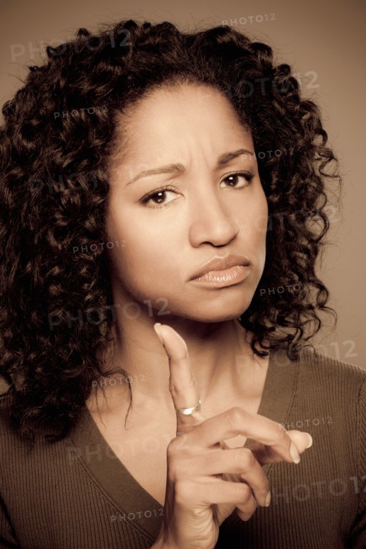 Studio shot of displeased mid adult woman. Photo : Rob Lewine