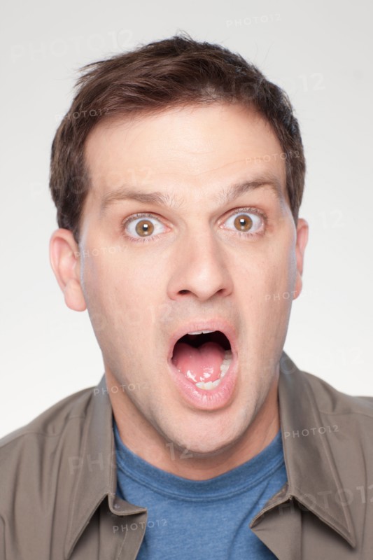 Studio shot of shocked mid adult man. Photo : Rob Lewine