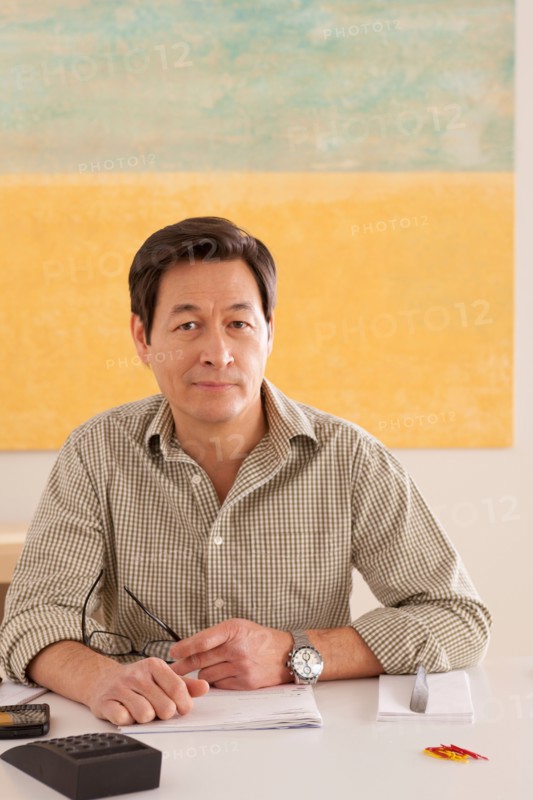 Portrait of man doing paperwork. Photo : Rob Lewine