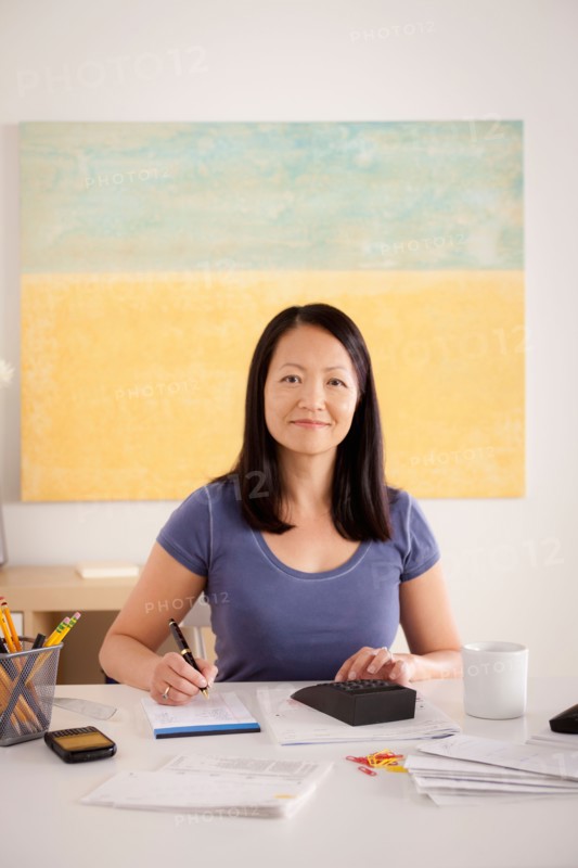 Portrait of woman doing paperwork. Photo : Rob Lewine