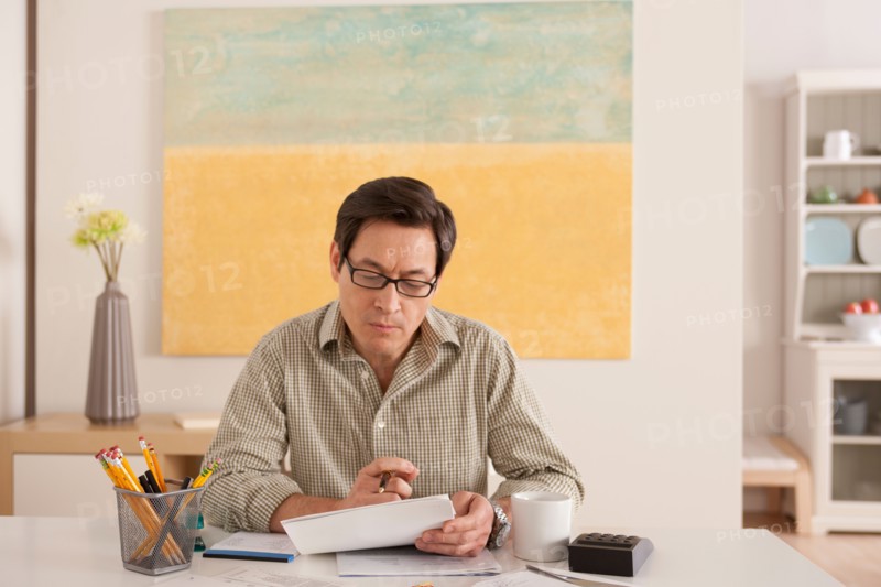 Man doing paperwork. Photo : Rob Lewine