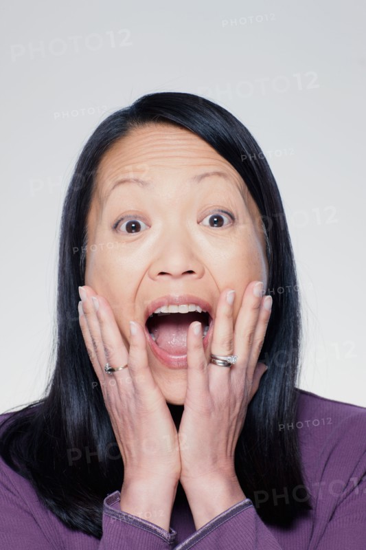 Studio portrait of mature woman screaming. Photo : Rob Lewine