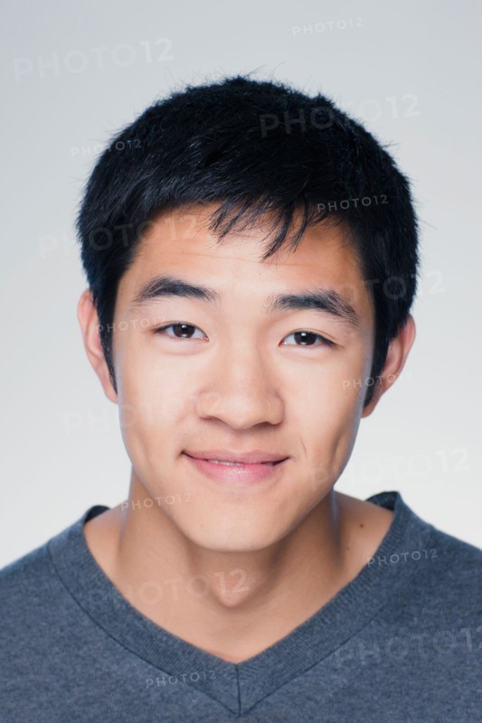Studio portrait of young man smiling. Photo : Rob Lewine