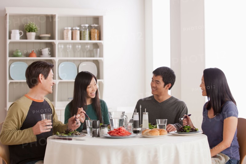 Happy family having meal together. Photo : Rob Lewine