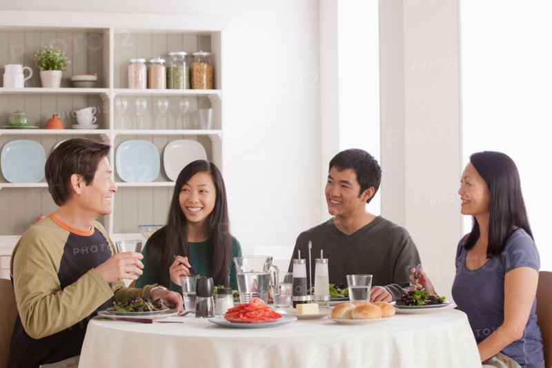 Happy family having meal together. Photo : Rob Lewine