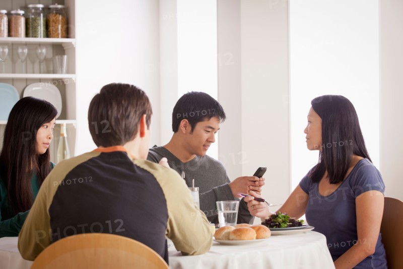 Happy family having meal together. Photo : Rob Lewine