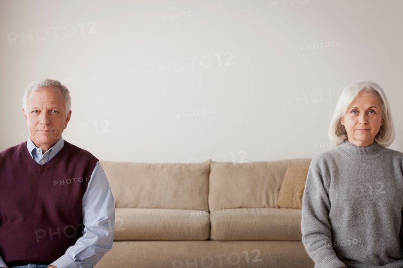 Portrait of senior couple sitting on sofa. Photo : Rob Lewine