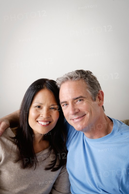Couple in close embrace sitting on sofa. Photo : Rob Lewine